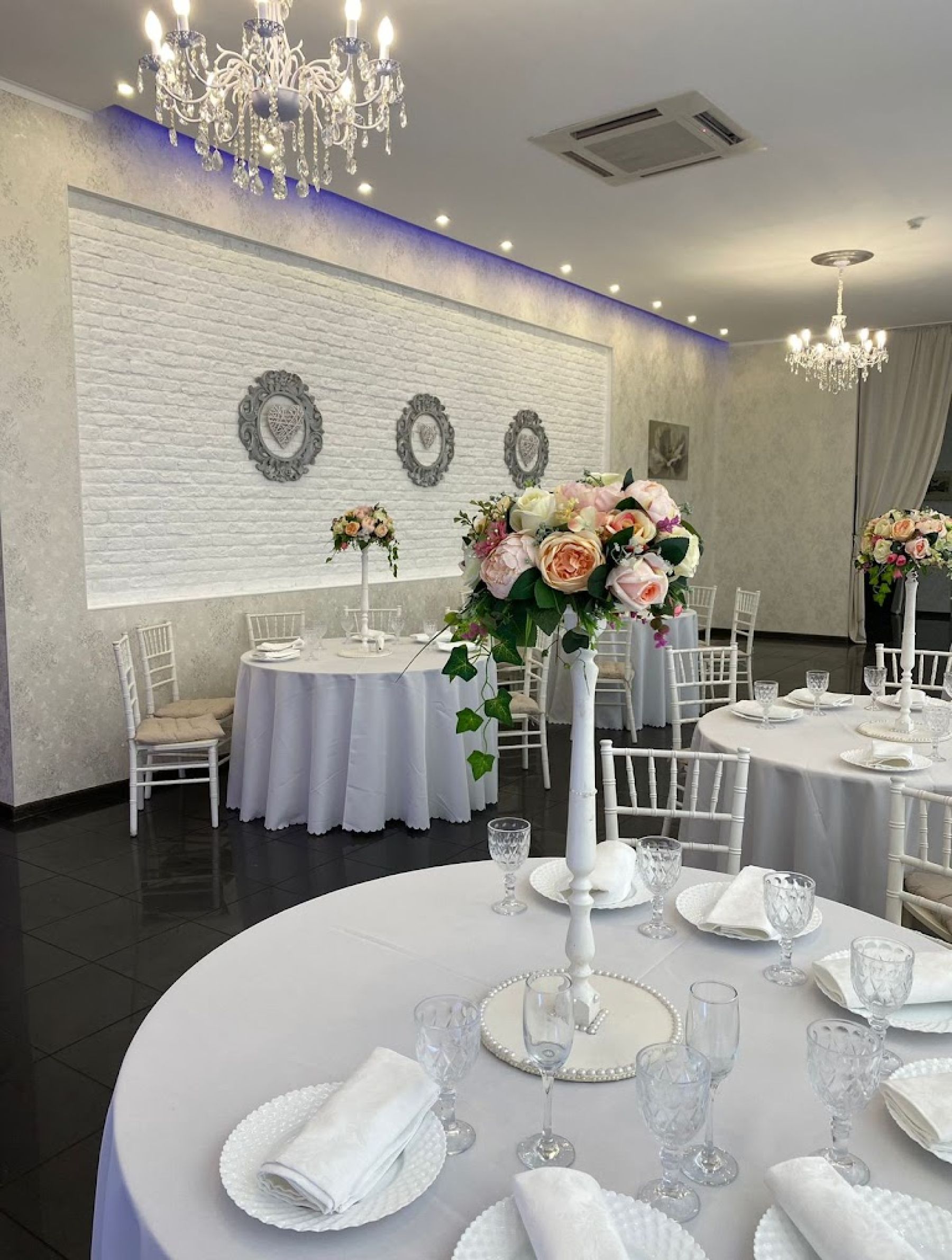 Интерьер банкетного зала с столами и люстрами